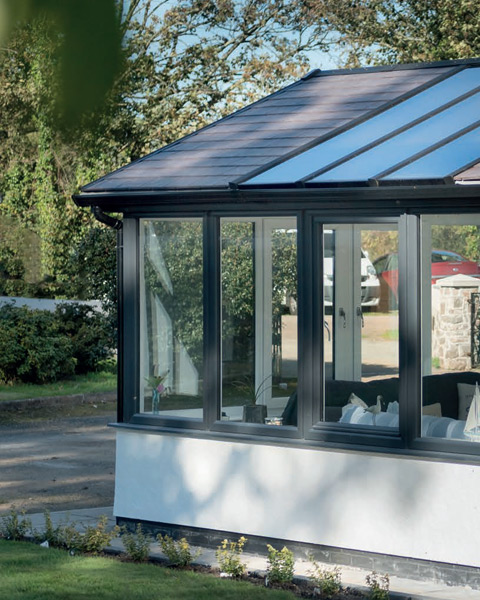 Modern anthracite grey conservatory with a solid roof