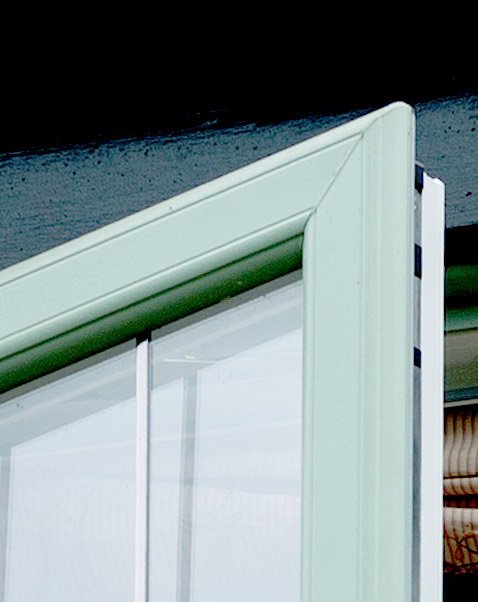 Closeup of green sculptured sash window