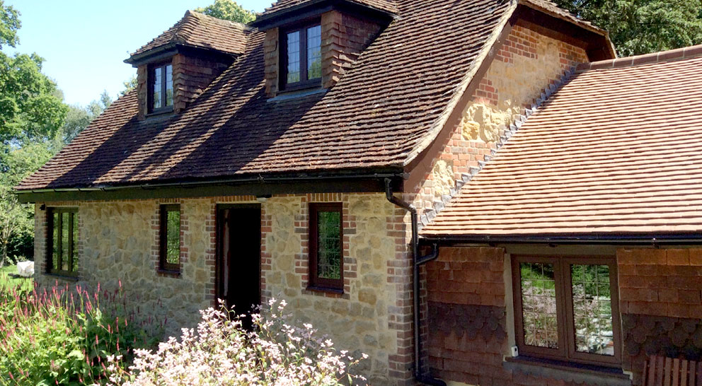 Cottage with dark timber effect uPVC windows