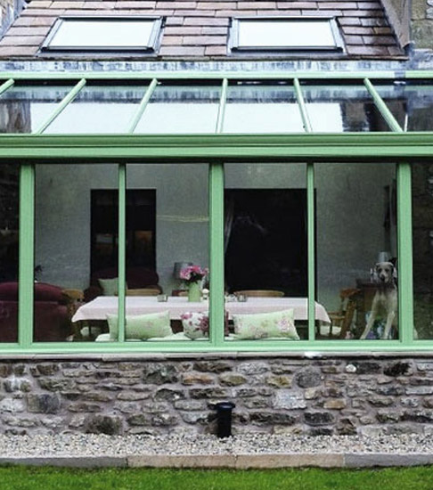 Stylish green framed glass lean-to conservatory