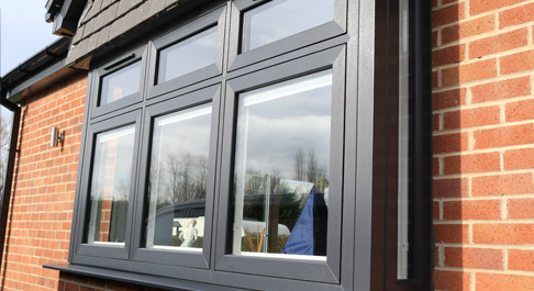 Anthracite window frames, red brick bungalow