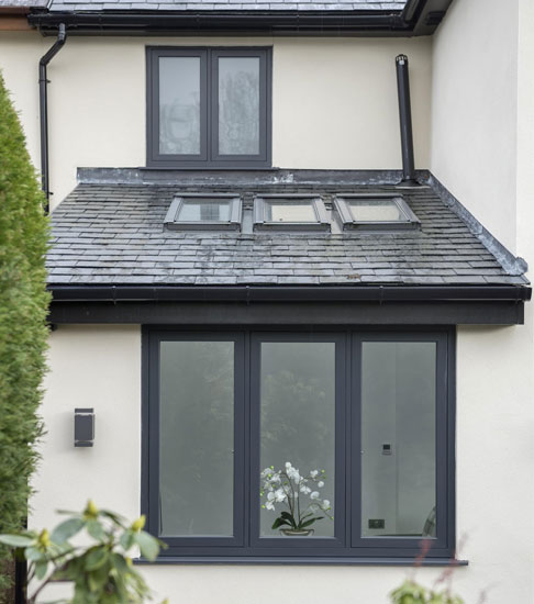 White rendered house with anthracite window frames
