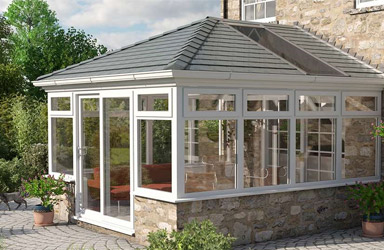 A conservatory with a solid insulated tiled roof